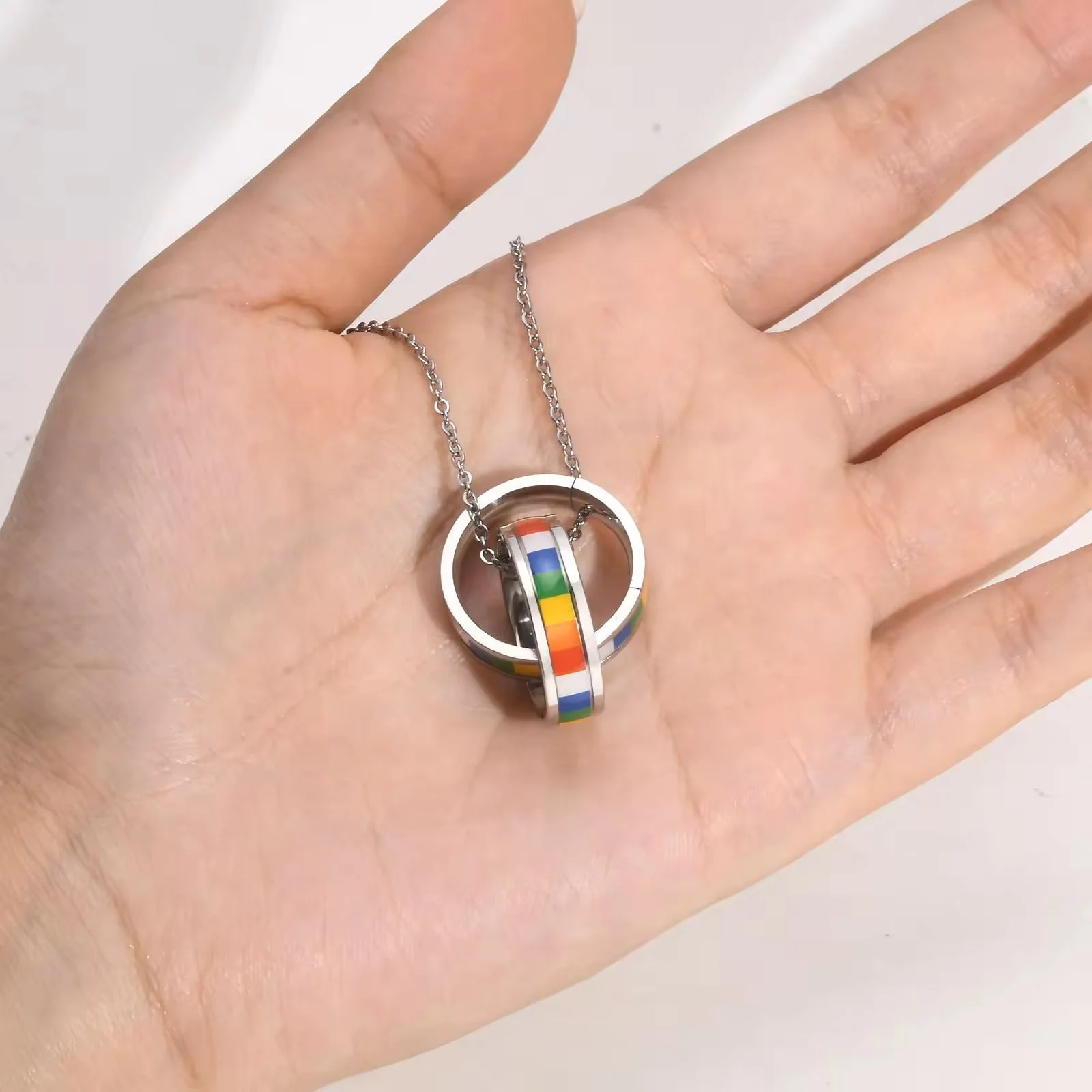 Double Ring Rainbow Pendant in hand
